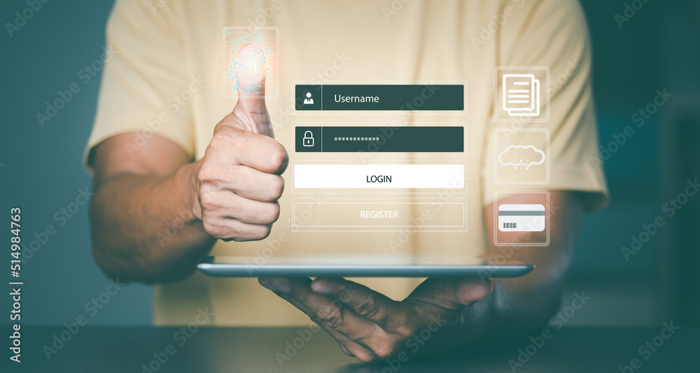 Wall mural man holding the tablet in hand and scanning fingerprint to access internet,