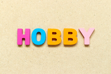 Color alphabet letter with word hobby on wood background