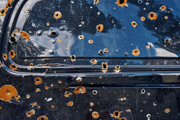 Back car window with bullet holes from Russian army