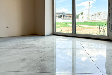 Laying white marble tiles on the floor.