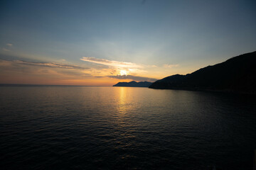 Naklejka na ściany i meble Beautiful sunset at the Mediterranean Sea in Italy. Vacation feeling during sunrise and sunset