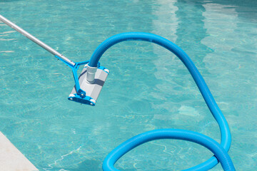 Close up view of automatic swimming pool cleaner before entering the water with water background