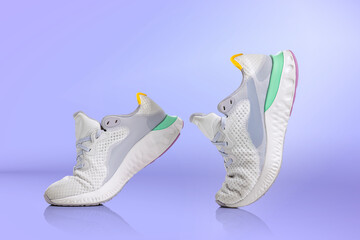 Strolling sports shoes on lilac color background. Sneakers or trainers isolated. Athletic shoes. fitness, sport, training concept. Urban fashion