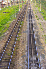 Fototapeta na wymiar Empty parallel railway tracks recede into distance. Travel or industrial background