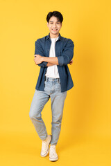 Smile happy asian man wearing shirt with jeans and laughing isolated on yellow background