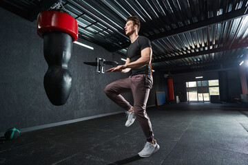 Sportsman performing one-leg jump during plyometric workout
