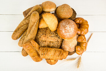 Bread, baguettes and sweet pastries on a white .