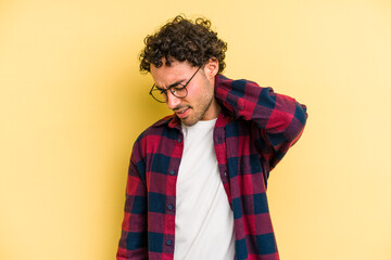 Fototapeta premium Young caucasian man isolated on yellow background having a neck pain due to stress, massaging and touching it with hand.