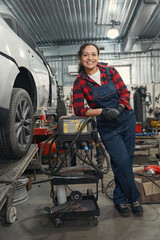 Fototapeta na wymiar Happy car mechanic posing on camera in garage