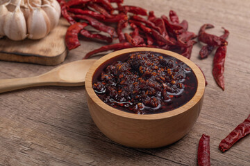 Thai spicy chili paste in a wooden cup (nampnikpao)