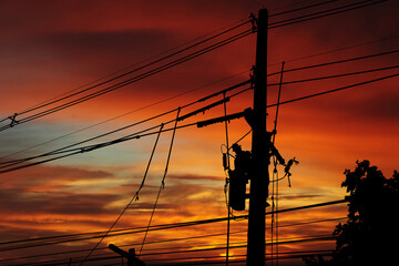 Silhouette of electrician high voltage  worker are working to fix power outages in the evening.
