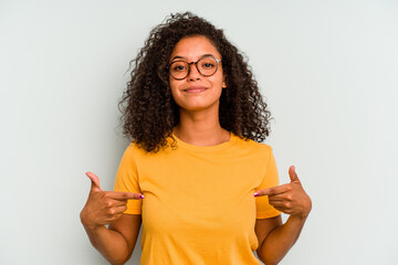 Young Brazilian woman isolated on blue background person pointing by hand to a shirt copy space,...