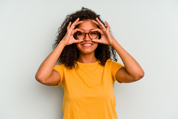 Young Brazilian woman isolated on blue background excited keeping ok gesture on eye.