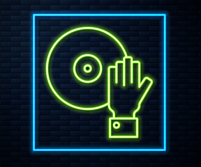 Glowing neon line DJ playing music icon isolated on brick wall background. Vector