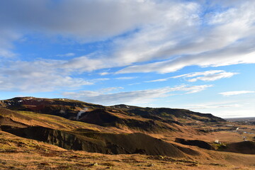 Volcanic hills in autumn sun. Reykjadalur, the Valley of Steam, beautiful geothermal region in Iceland