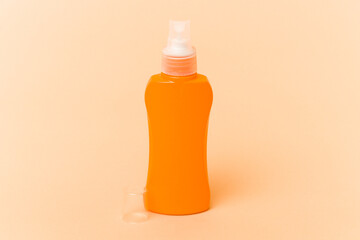 Sun cream isolated on beige background