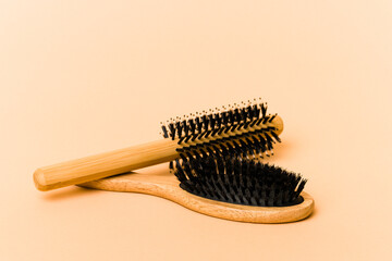 Two types of hairbrush isolated on beige background - obrazy, fototapety, plakaty