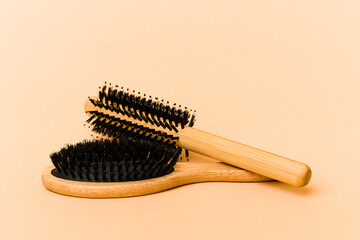 Two types of hairbrush isolated on beige background
