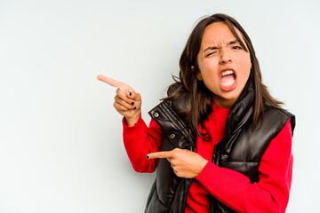 Young hispanic woman isolated on blue background showing fist to camera, aggressive facial expression.