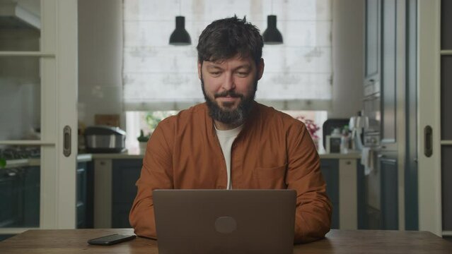 Man happy working a computer laptop indoors
