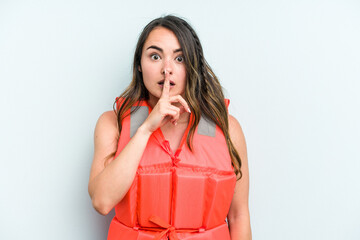 Young caucasian woman wearing life jacket isolated on blue background keeping a secret or asking for silence.