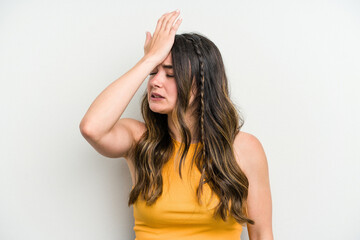 Obraz premium Young caucasian woman isolated on white background forgetting something, slapping forehead with palm and closing eyes.