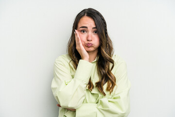 Obraz premium Young caucasian woman isolated on white background blows cheeks, has tired expression. Facial expression concept.