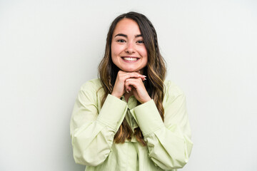 Young caucasian woman isolated on white background keeps hands under chin, is looking happily aside.