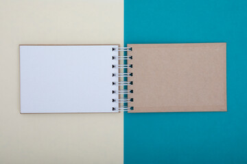 Top view on open craft sketchbook being on bicolored surface. Place for text and copy space concept