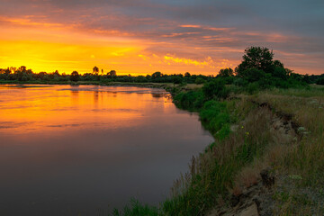 Fototapeta na wymiar fiery sunset river bug july