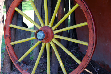 
Old cart wheel. Wooden wheel of old cart. Ancient wheel. Field work tool. Colorful wheel used as a...