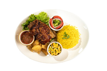 pork rinds with Valencian rice, yucca, corn, sauce and salad with tomato, onion and lettuce on a white plate