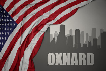 abstract silhouette of the city with text Oxnard near waving national flag of united states of america on a gray background. 3D illustration