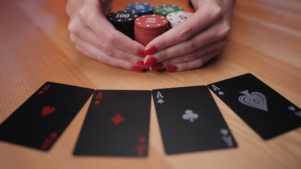 Female person win poker game bet with double double ace cards grab the reward