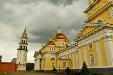 Fototapeta na wymiar Cloudy day, Orthodox church and old factory tower