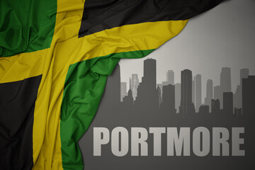 abstract silhouette of the city with text Portmore near waving national flag of jamaica on a gray background. 3D illustration - obrazy, fototapety, plakaty