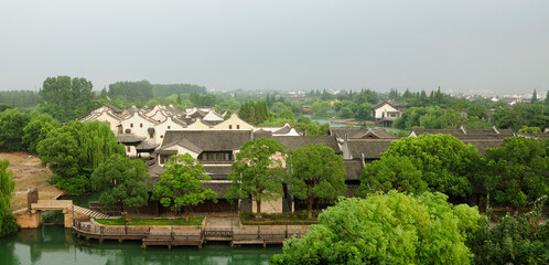 Fototapeta na wymiar An elevated view of the Chinese style buildings in Tongxiang's Wuzhen West Scenic Area on a hazy cloudy day in Zhejiang Province China.
