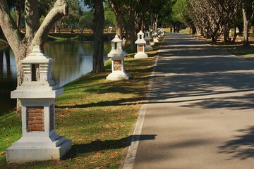 White cement lamps decorate the walkway in the Sukhothai Historical Park.