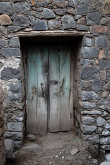 Old wooden door with black rock stone house in the village of Maharashtra, India, Generic background and pattern.