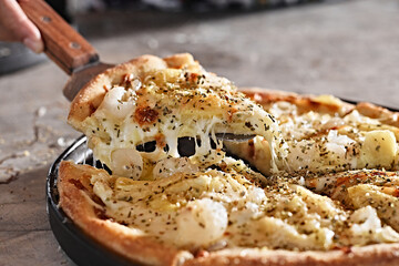 Hands picking up homemade flatbread pizza