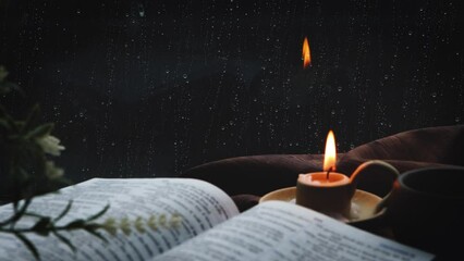 The rain falling on the window, the flowing raindrops, the soothing sound of rain, the cross, the candle, and the Bible symbolizing the suffering, death and resurrection of Jesus Christ