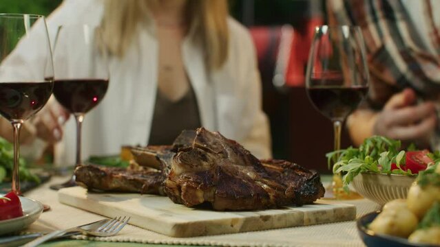 man puts a plate of meat on the table