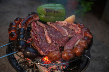 Typical Uruguayan and Argentine Asado Cooked on fire. Entrana and Vacio meat cuts. Accompanied with...