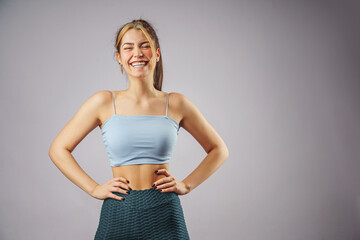 Portrait of happy fitness young woman smiling while exercising.