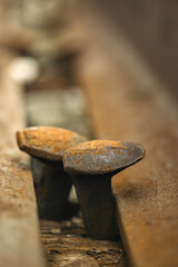 Bolts on a train track used by commuter and freight trains in a suburban town. 