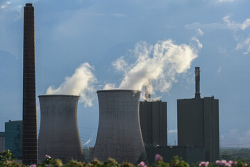 Chimney and cooling towers with steaming pollution of the steel production industry in Duisburg...