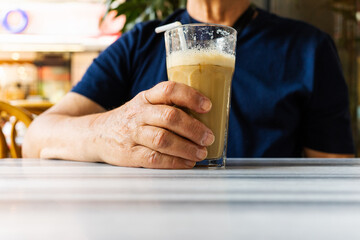 Man with a cold coffee mug on the marble table