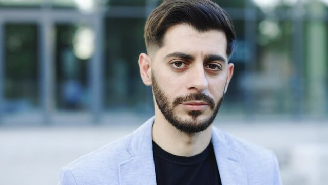 Close-up portrait of nice-looking caucasian multi-race beautiful businessperson elegant young man looking into camera. Career people. Fashion, beauty. Male portrait