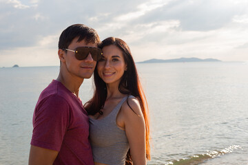 Portrait of Caucasian couple in casual style embrace at outdoor together in summer time. people travel vacation to the beach. happy lifestyle