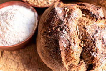 Round bread close-up. Freshly baked sourdough bread with a golden crust. Baker shop context with delicious bread.